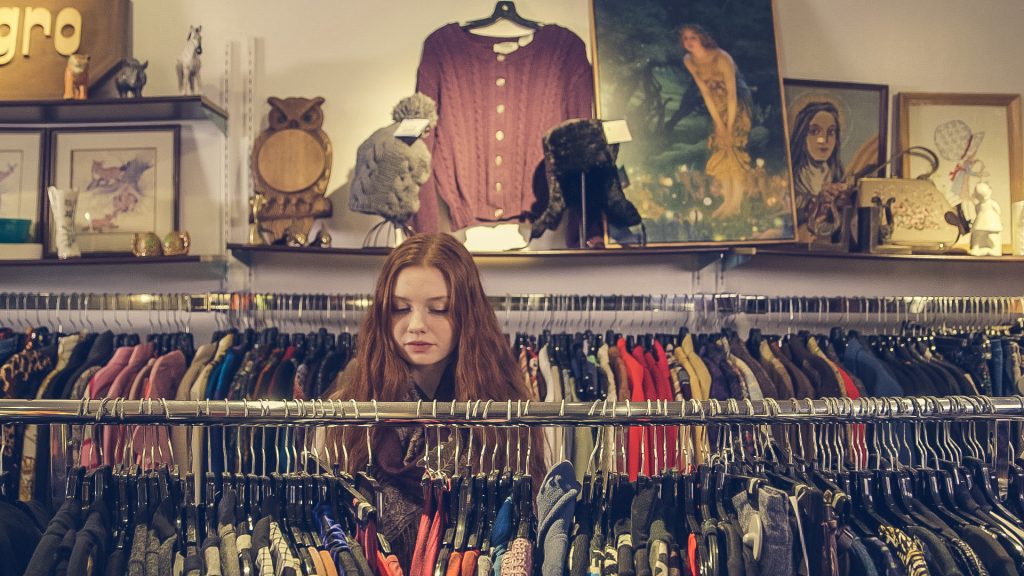 Canva Photo of Woman Near Clothes